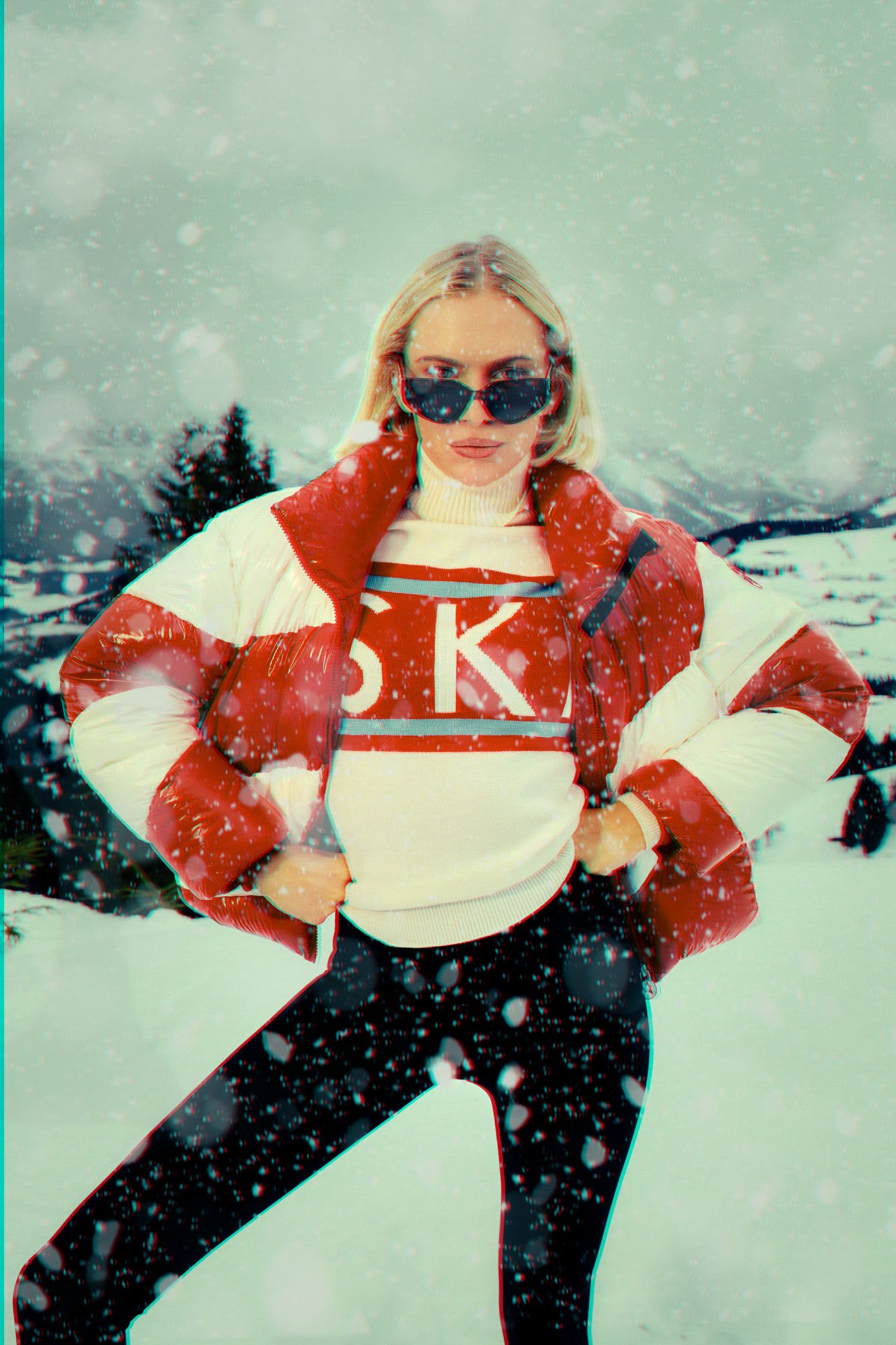 a woman in a snow jacket posing in the snow