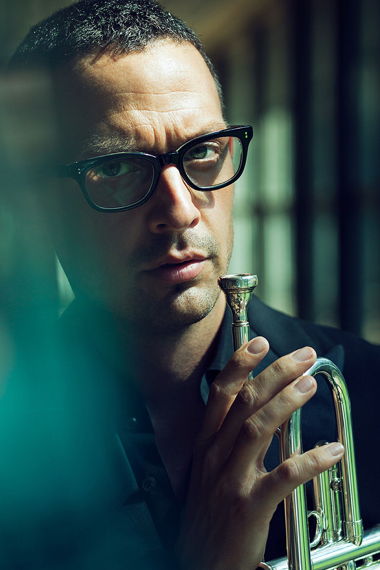 till broenner with glasses is holding a trumpet
retouche by glamtouch