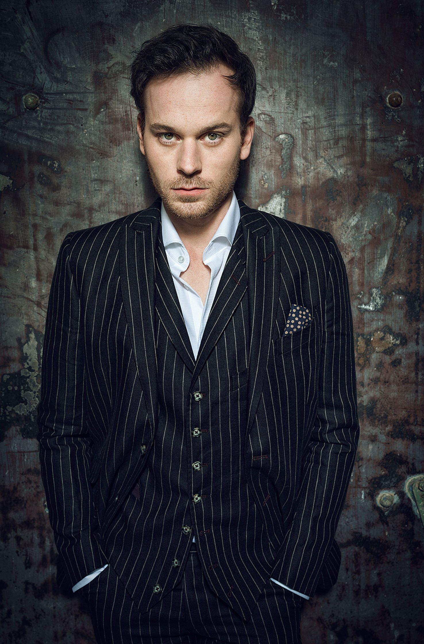 florian bartolomaei in a pinstripe suit posing against a wall
retouche by glamtouch