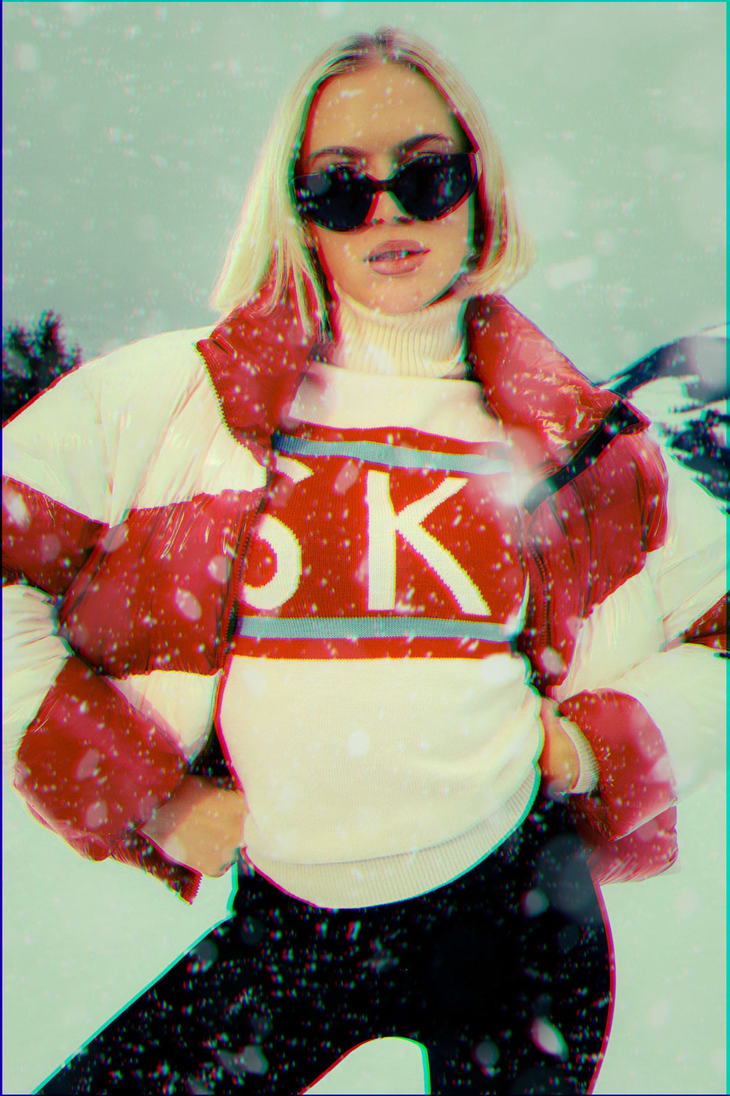 a woman in a red and white sweater posing in the snow