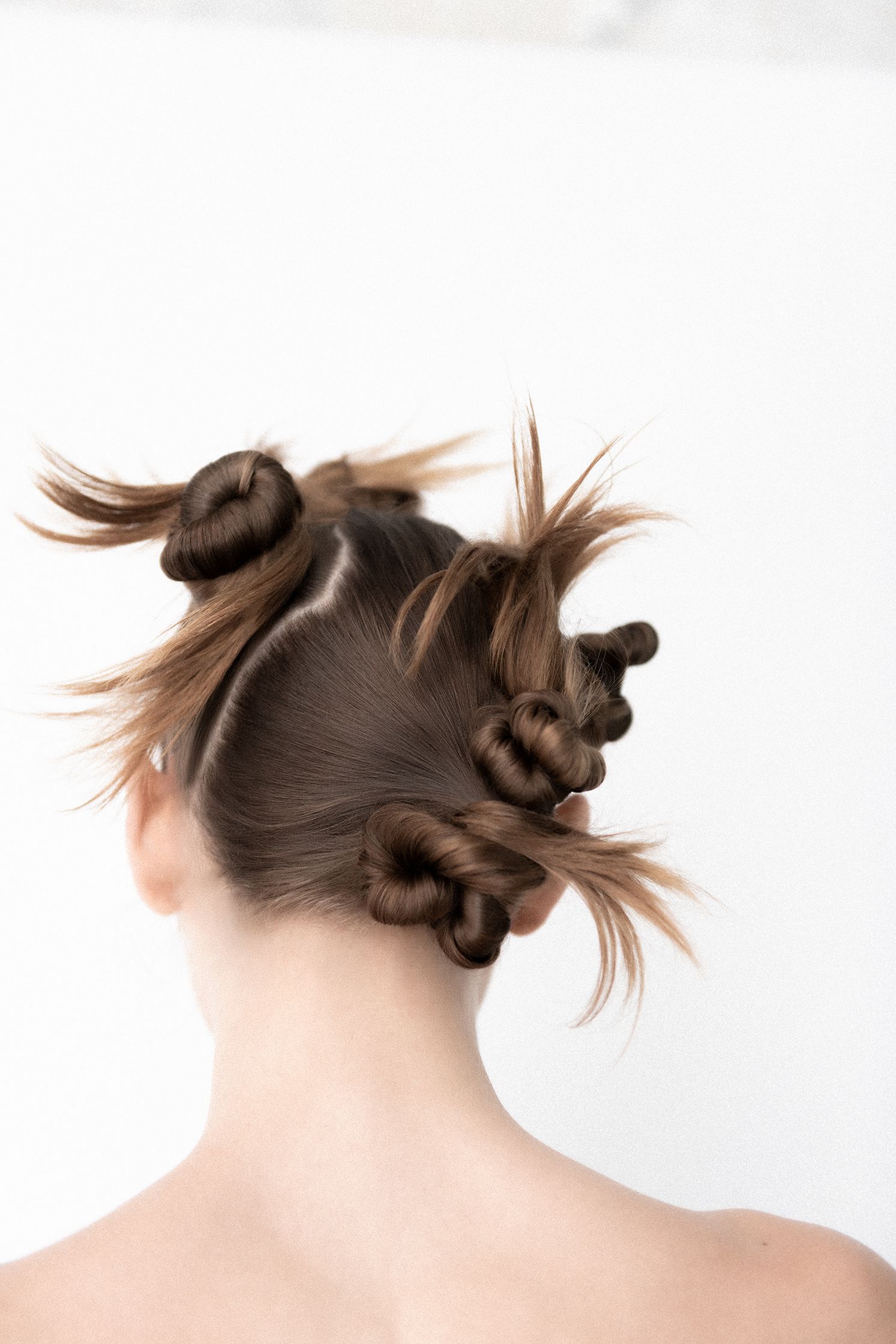 the back of a woman with her hair in a ponytail