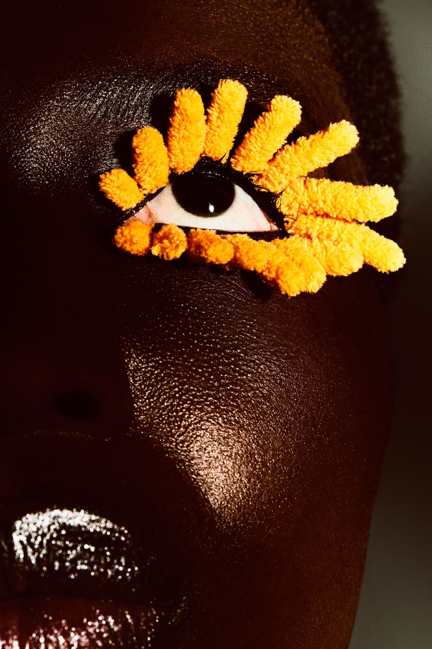 a black woman's face with a yellow flower on her eye