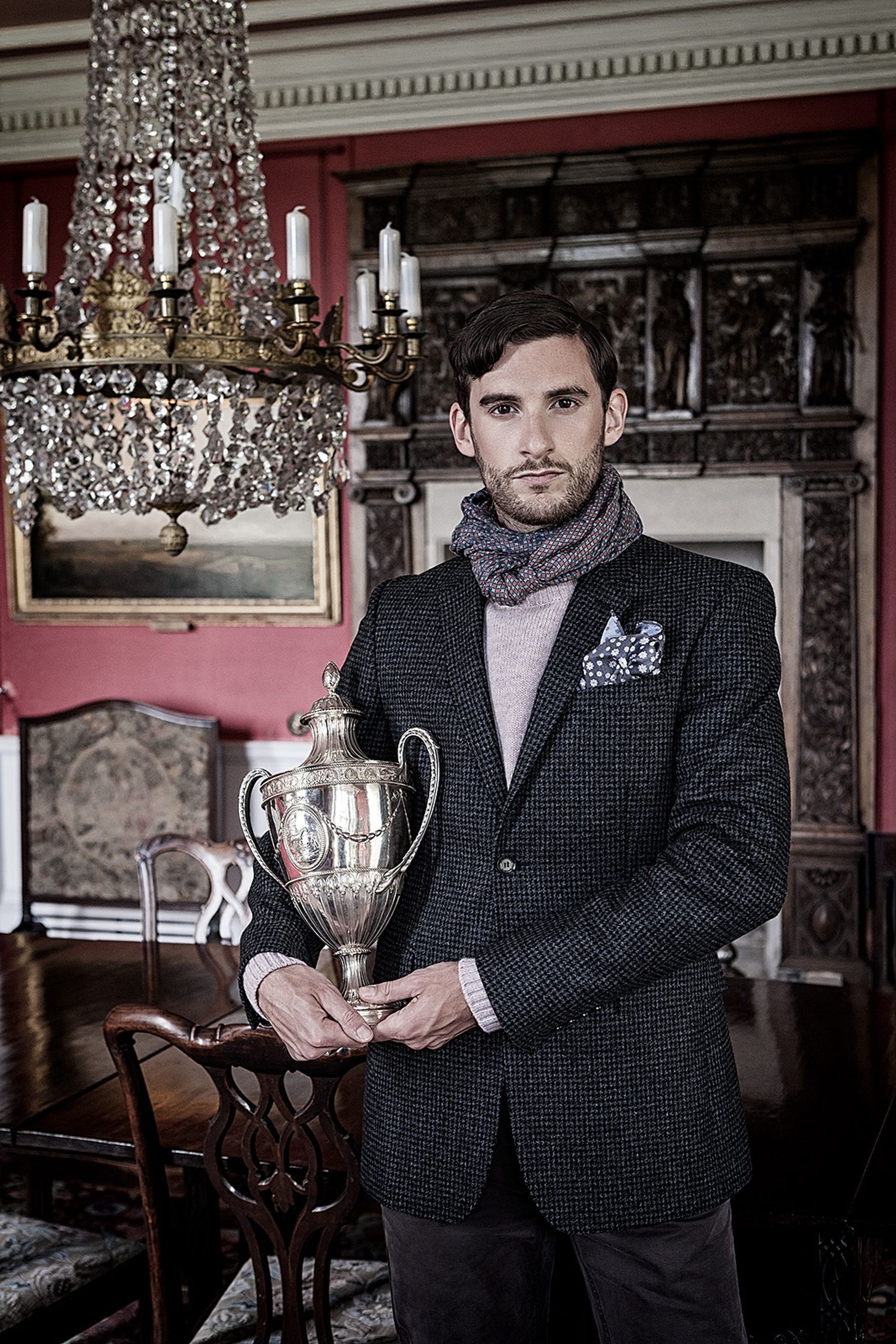 a man holding a trophy creative post production