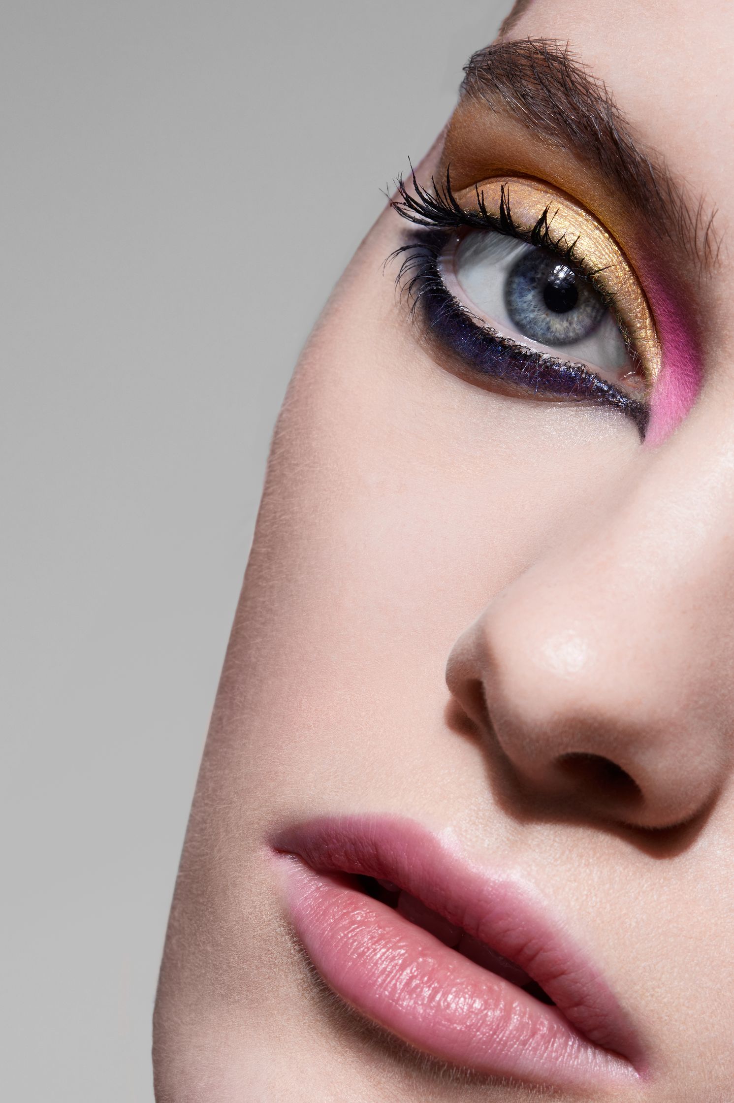 a close up of a woman's eye with colorful eye makeup