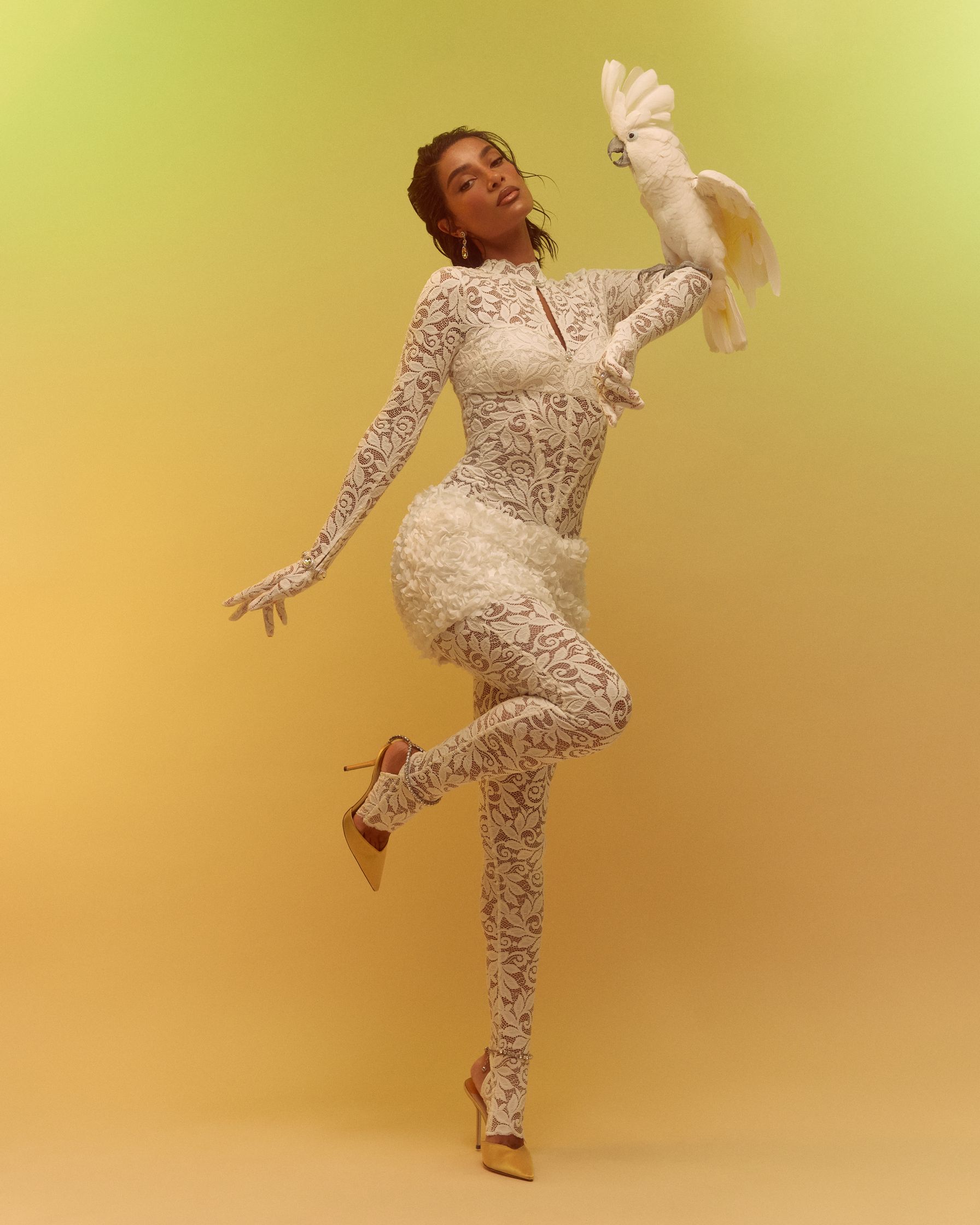 a woman in a white dress is holding a stuffed animal